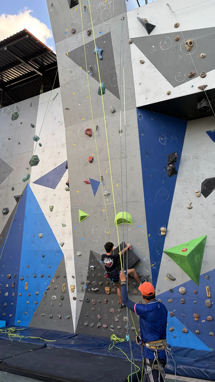An Acton Academy El Salvador learner on the climbing wall with the school team