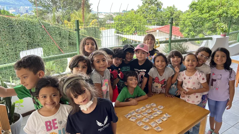 The Montessori preschool group gathered around a table outdoors