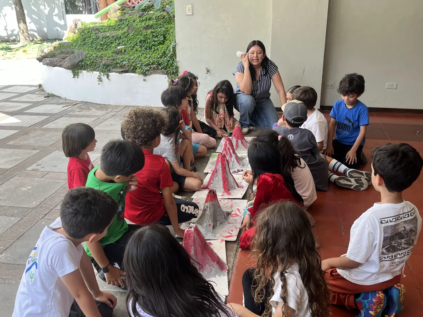 Acton Academy El Salvador learners and a guide gathered together outdoors